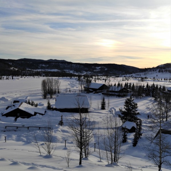 Colorado snowshoe resort: cabins at Vista Verde covered in snow with sunset in background