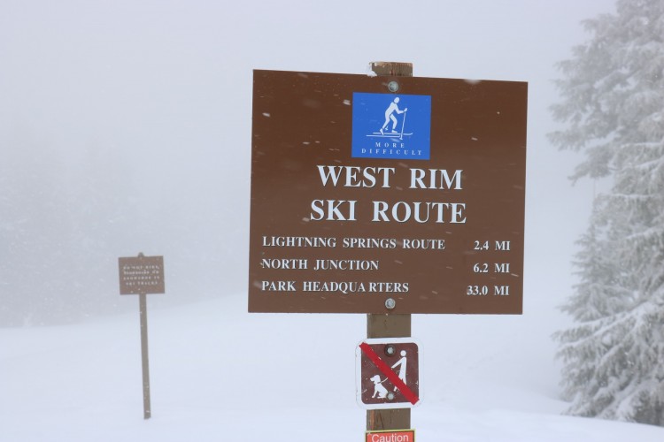Crater Lake National Park winter: trail sign at West Rim Drive in cloudy conditions
