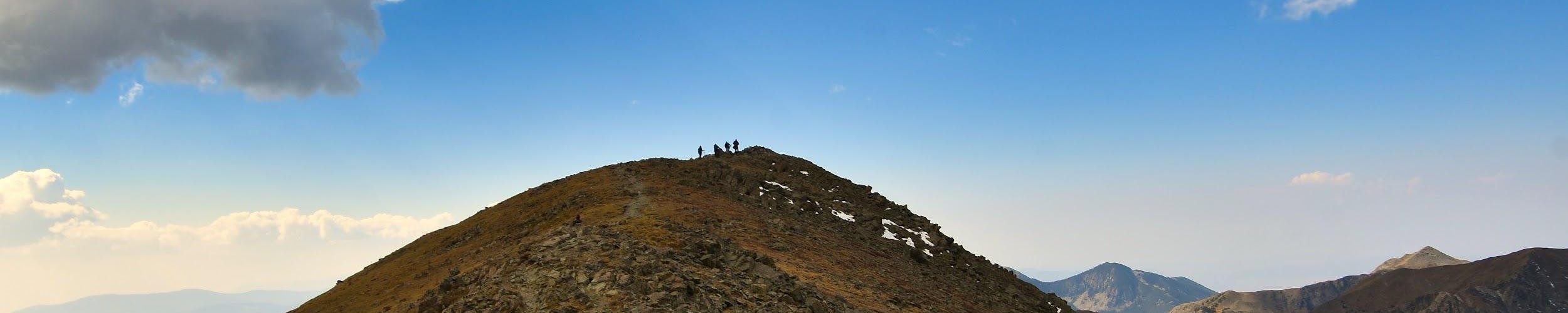 view of Wheeler Peak NM under blue sky with cloud