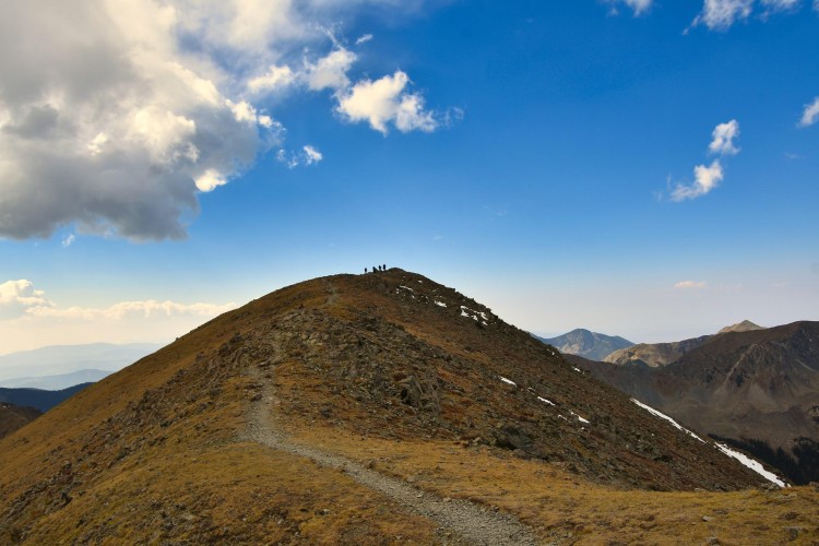 view of Wheeler Peak NM under blue sky with cloud