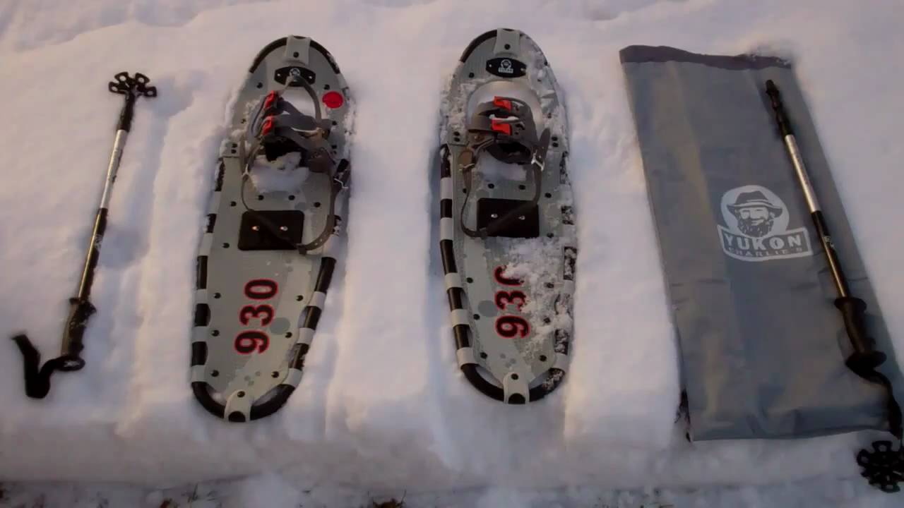 Yukon Charlies 930 kit on the snow (poles, snowshoes, bag)