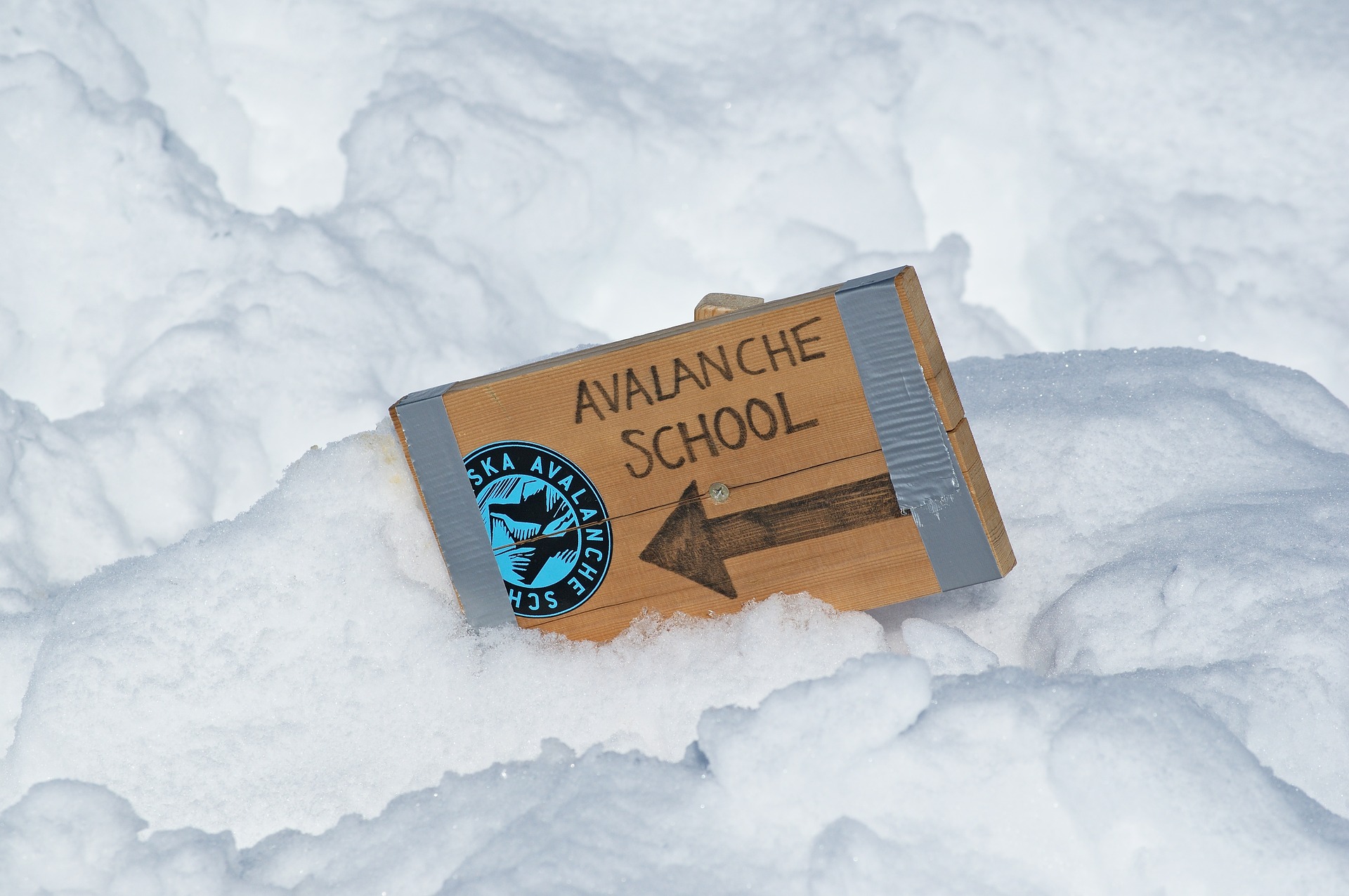 avalanche school sign in the snow