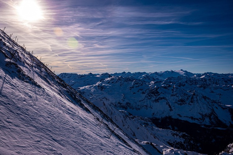 mountain slope with sun in the background