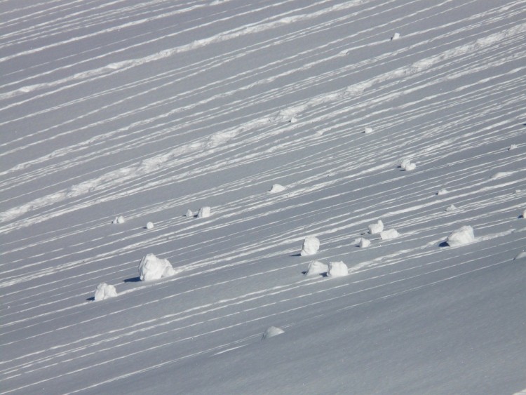 balls of snow on a snowy mountain slope