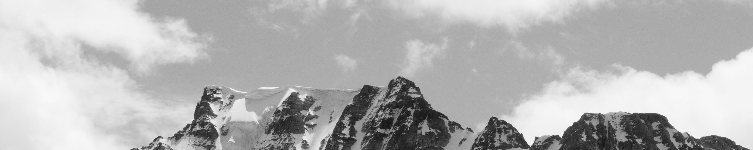 black and white photo of snow and sky