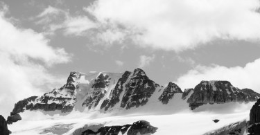 black and white photo of snow and sky