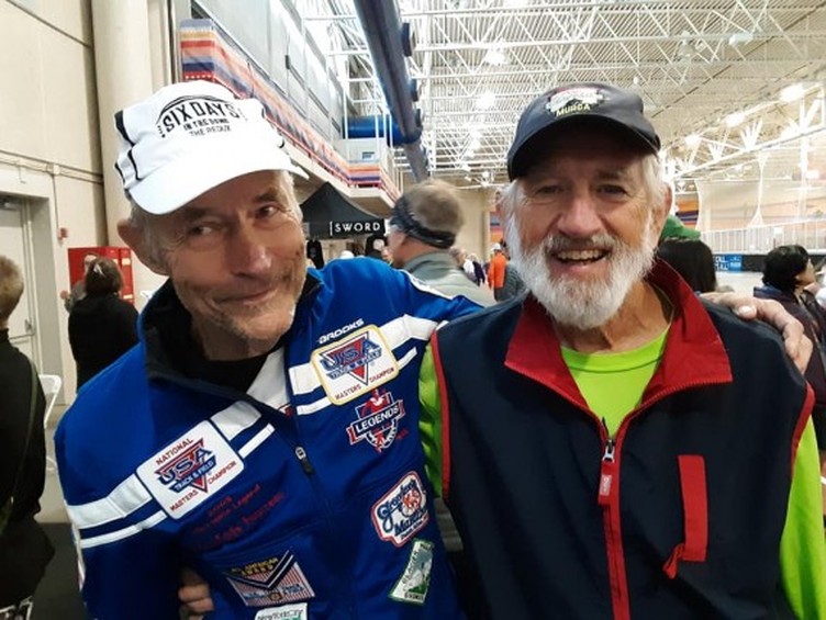 Two men smiling