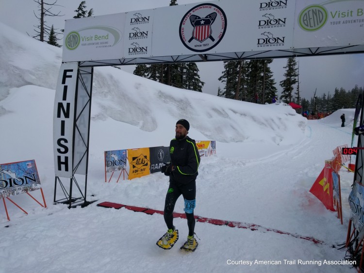 snowshoe racer crosses finish line at national race