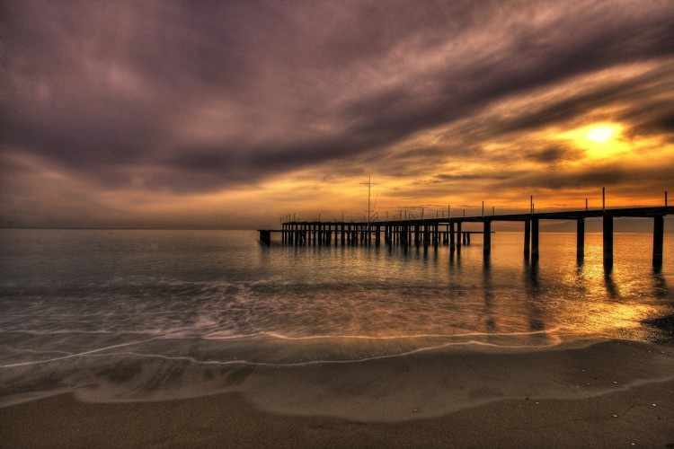 rain clouds with sun over the ocean