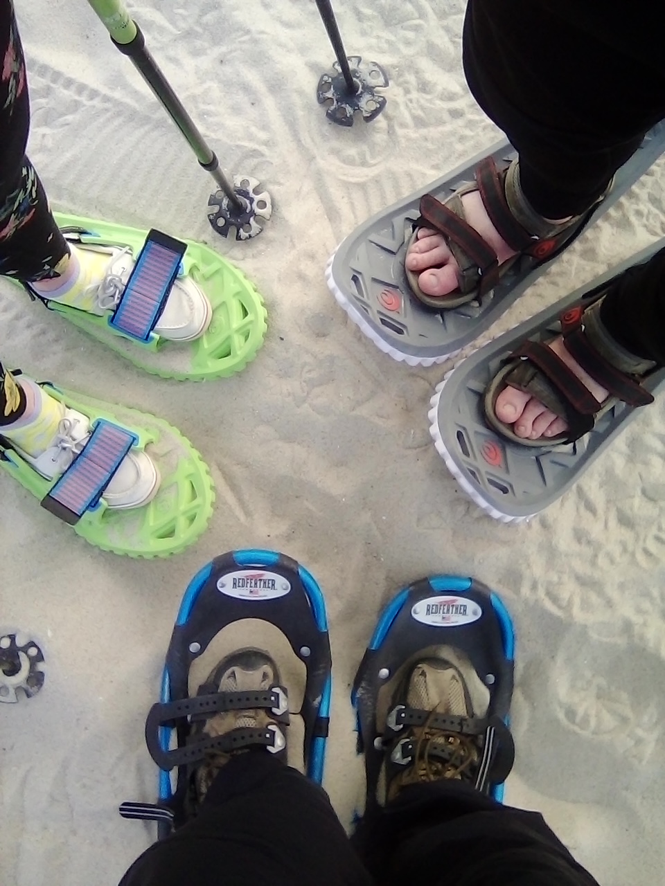 close up of three snowshoes on sand in a circle