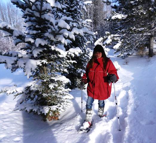 woman snowshoeing with two poles