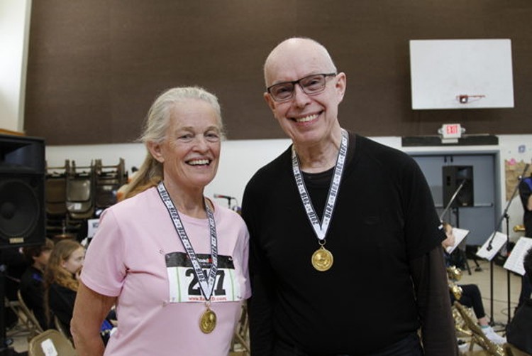 two people with medals around neck