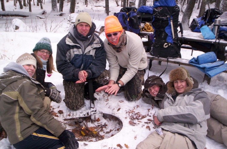 people around a campfire in winter