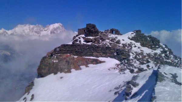 Ruins of the castle on the summit, with Grandes Jorasses behind.