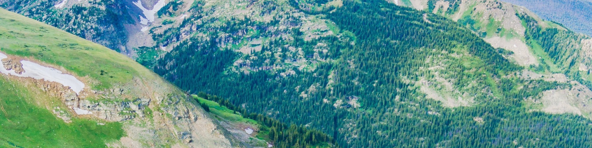man running on trail with view of the mountains