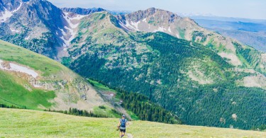 man running on trail with view of the mountains