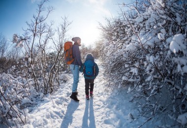 mom and child on winter hike in snow