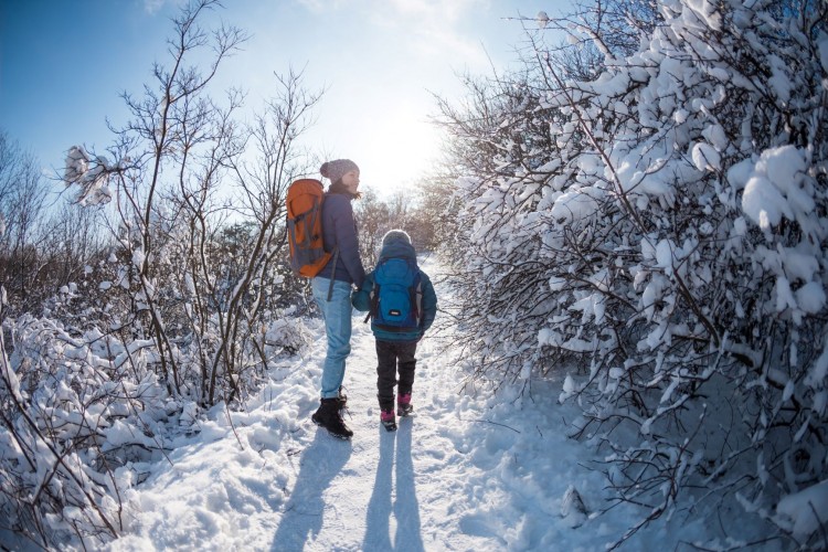 mom and child on winter hike in snow
