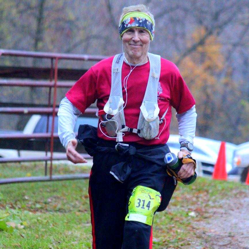 President's Fitness Challenge: man running and smiling with water bottle in hand at 2015 Surf the Murph race