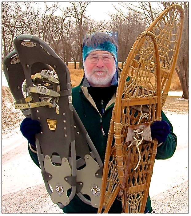 man holding snowshoes