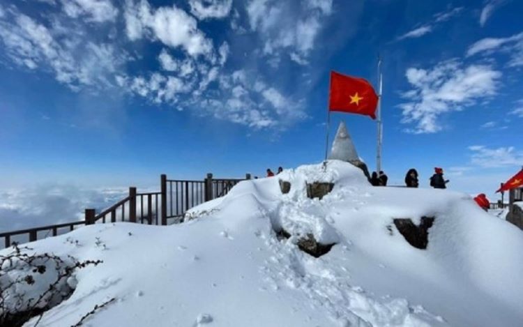 snow on Fansipan Mountain, Vietnam with blue sky above