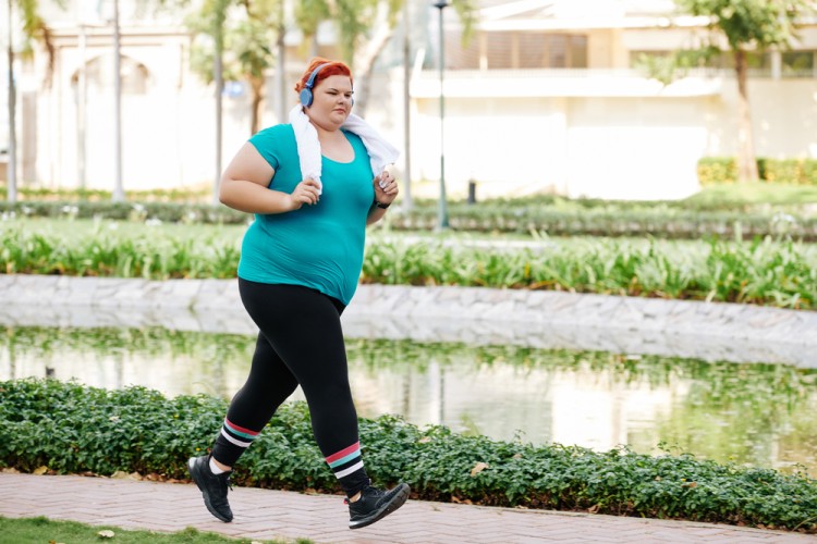 woman running outdoors in park in warm weather