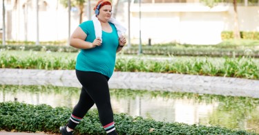 woman running outdoors in park in warm weather