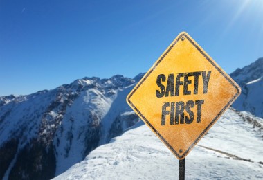 yellow safety sign in mountains surrounded by snow