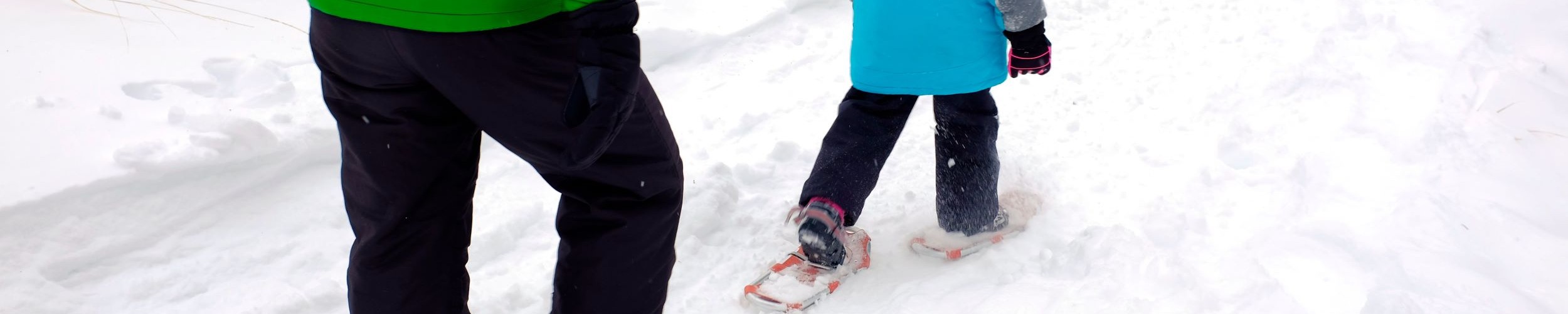 adult and child snowshoeing