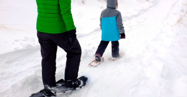 adult and child snowshoeing