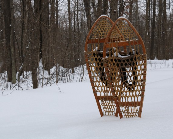 traditional snowshoes standing up in deep snow
