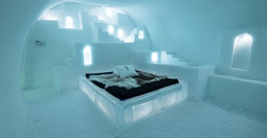 bed on iceblocks in room.