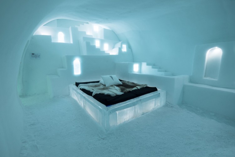 bed on iceblocks in room.