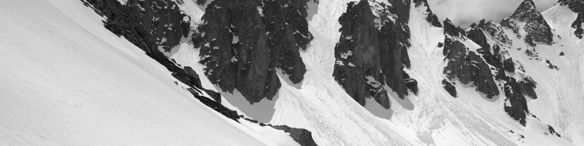 man snowshoeing near avalanche terrain