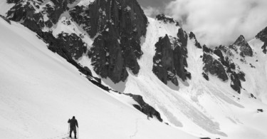 man snowshoeing near avalanche terrain