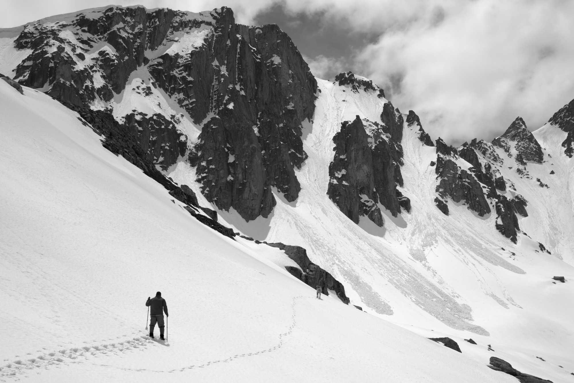 snowshoer underneath a slope with signs of avalanches ahead