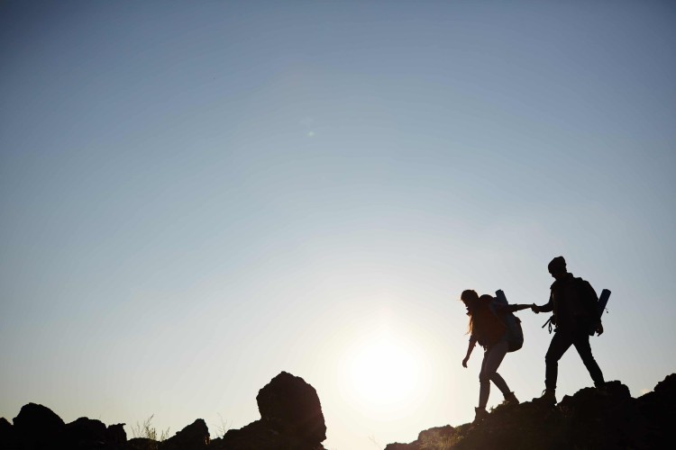 silhouette couple on mountain with blue background