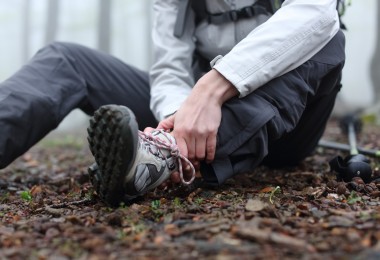 close up of person holding ankle on the trail