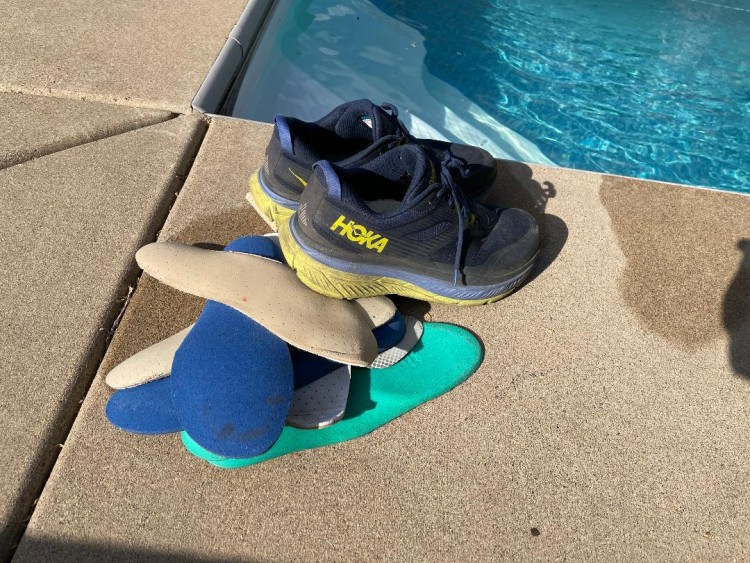 layers of shoe inserts near pool