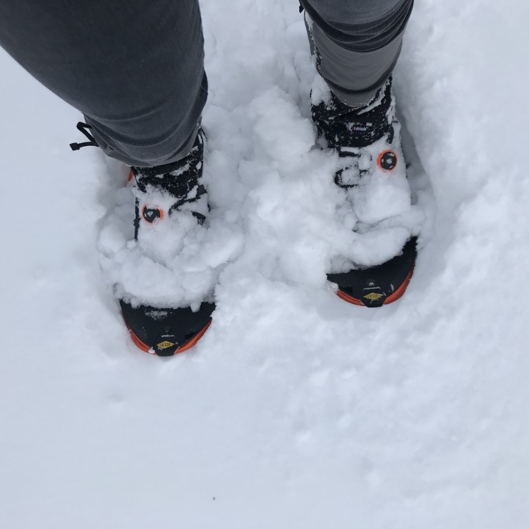 looking down on 'shoes filled with snow