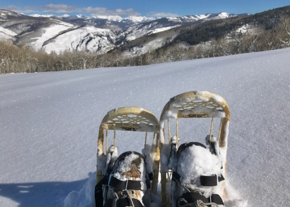 snowshoes overlooking mountains