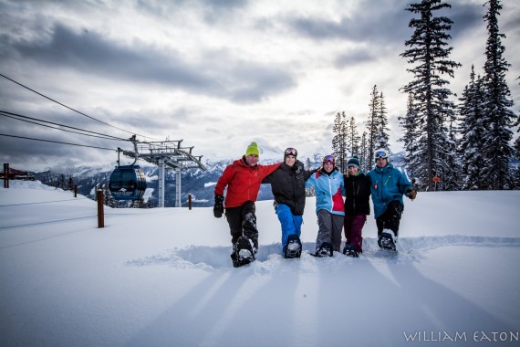 snowshoers near ski lift on snowshoe tour at Revelstoke Mountain Resort, British Columbia